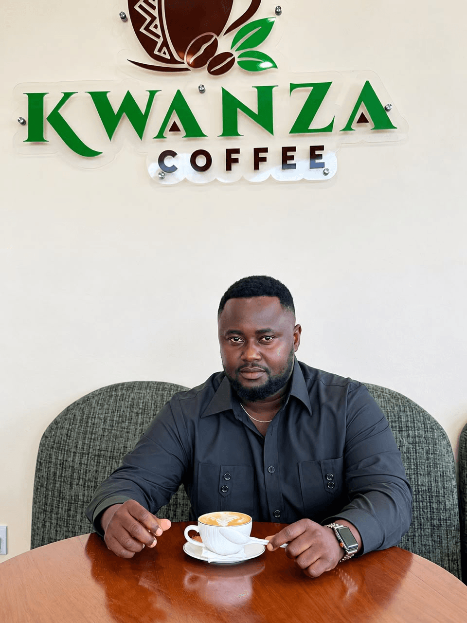 Dady Kayombo, Founder and Managing Director of Leoleo, seated at Kwanza Coffee